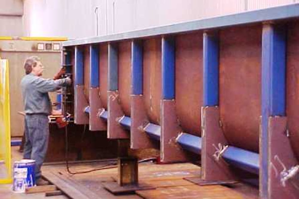 Painting a fabricated structure in the booth